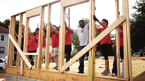 Volunteers building framing for a new home