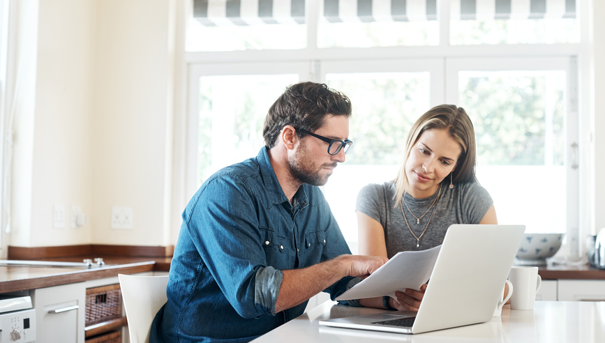 man and woman looking at computer