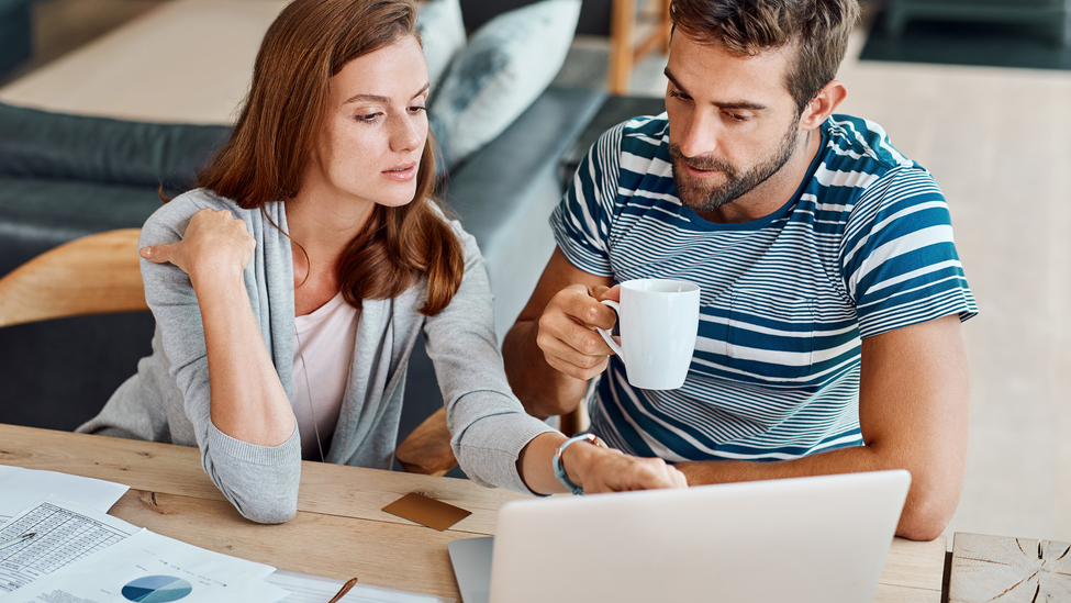 Couple looking at auto rates on their computer