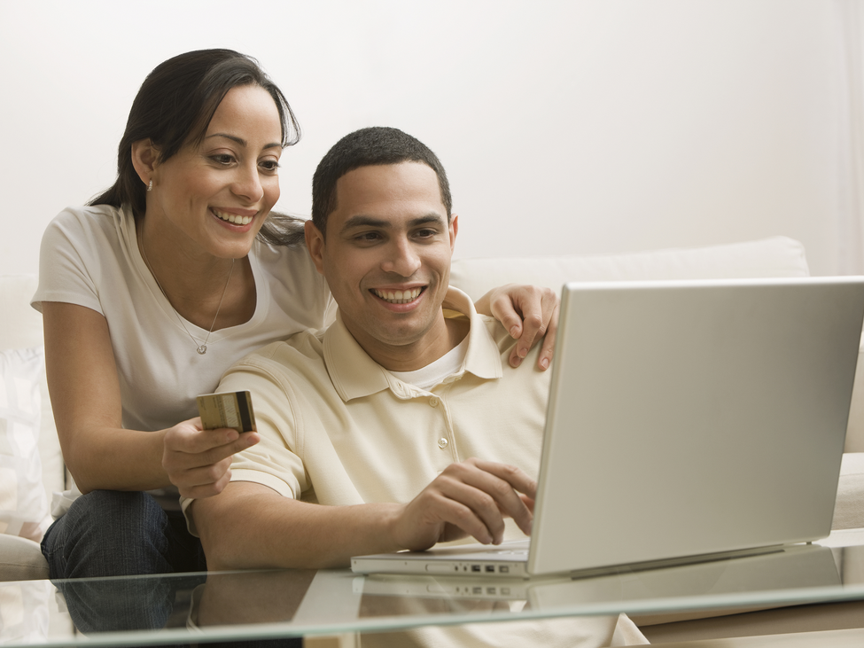 man and woman working on a laptop.