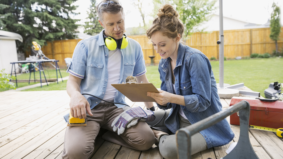 Couple fixing deck at home.