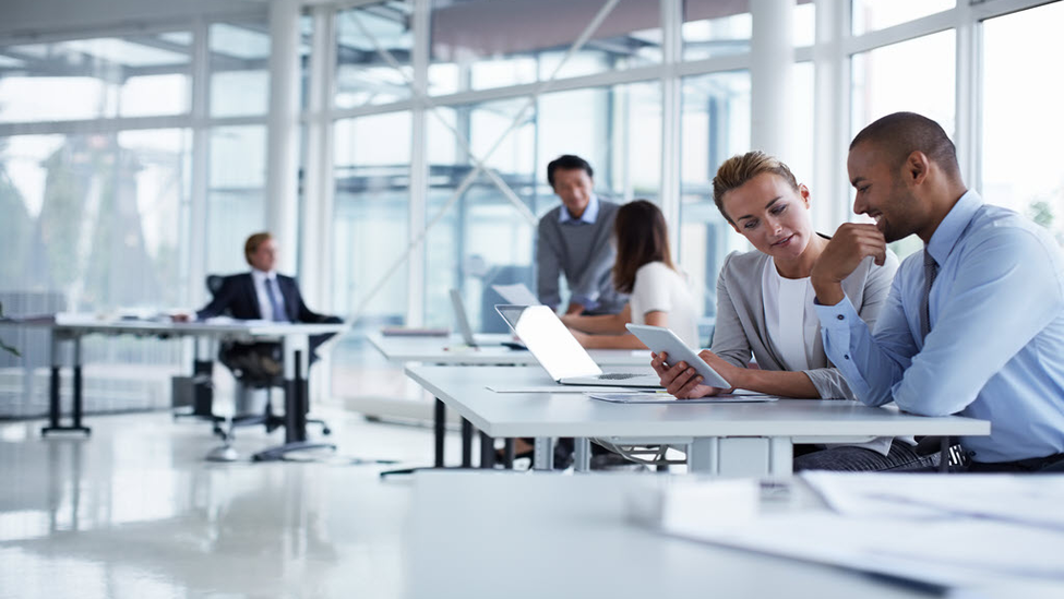 Business people sitting and talking over paperwork