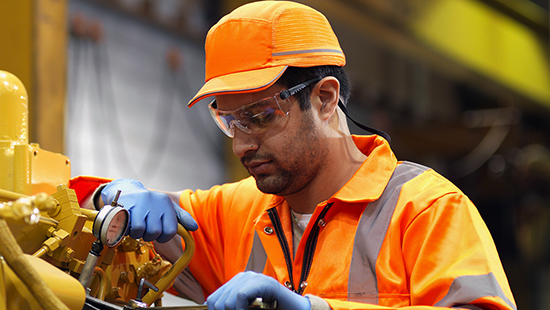 Man working on pipes in factory.