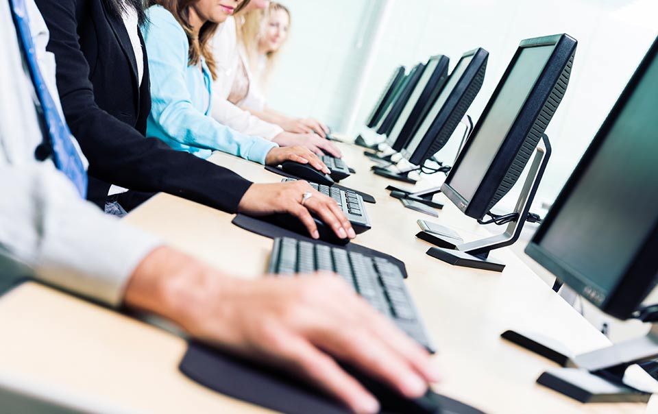 Employees at computers being trained on cyber security.