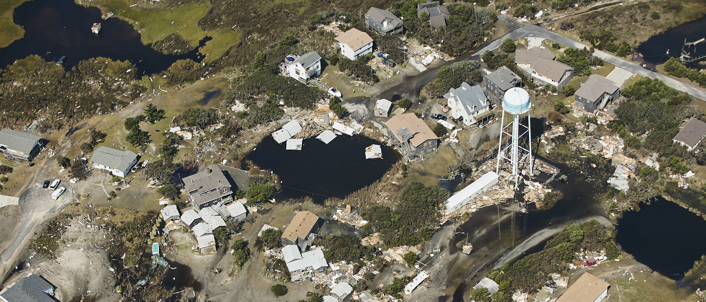 Damaged houses and roads from a severe weather.