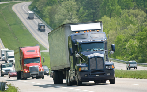 Dark blue truck driving along interstate