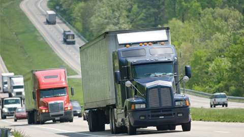 Dark blue truck driving along interstate