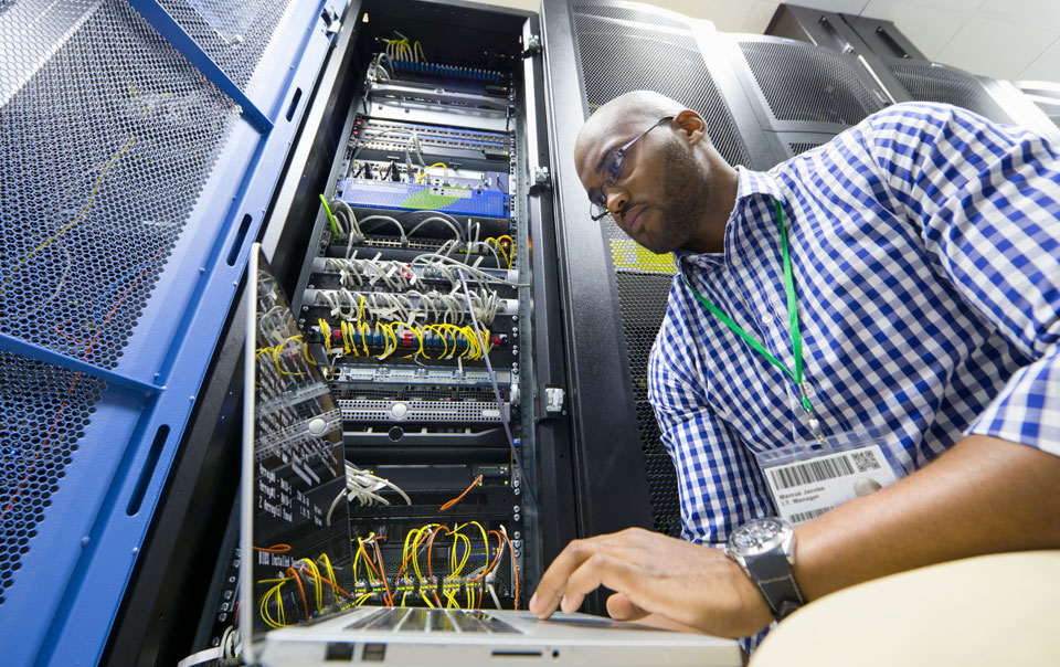 Digital forensics detective in server room investigating a data breach