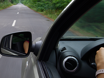 woman driving in forest