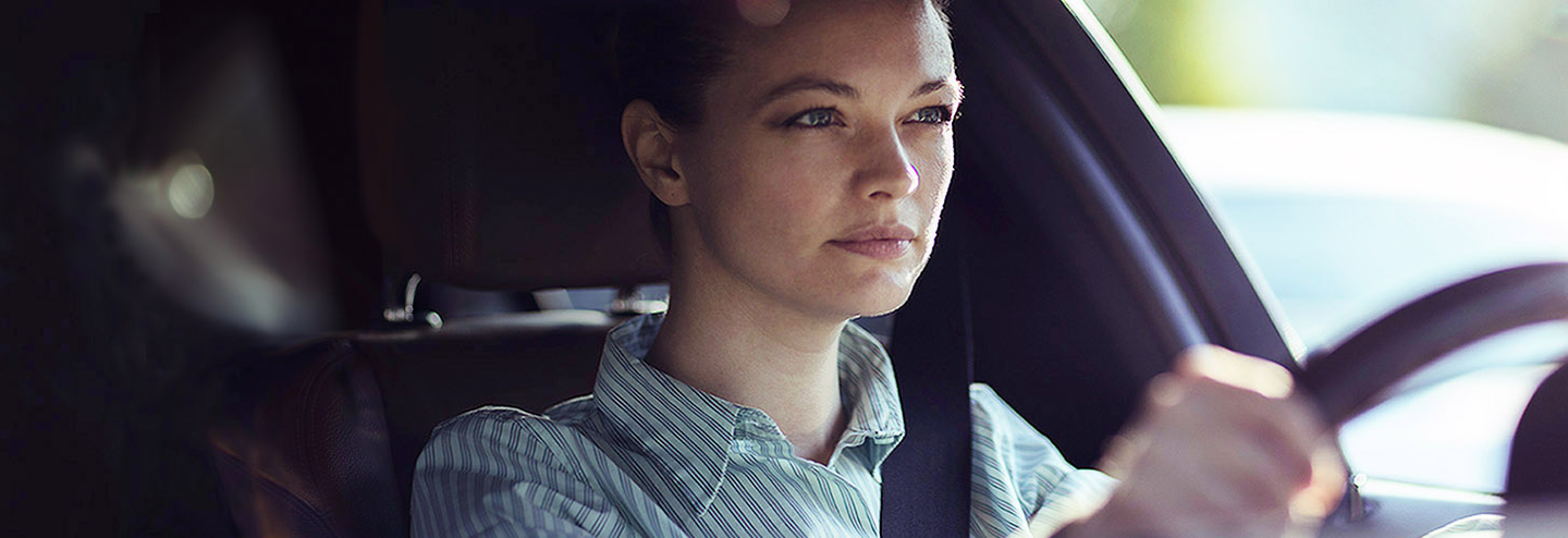 Teen driver focuses intently on driving a car.