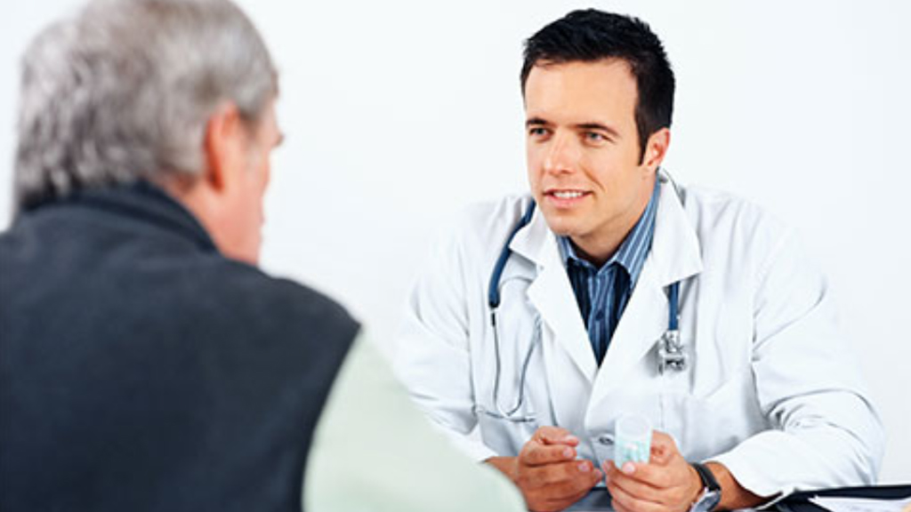 Doctor wearing stethoscope and lab coat advises truck driver