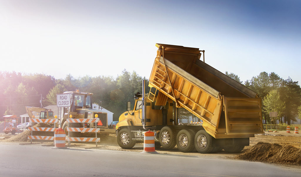 dump truck unloading - road closed sign.