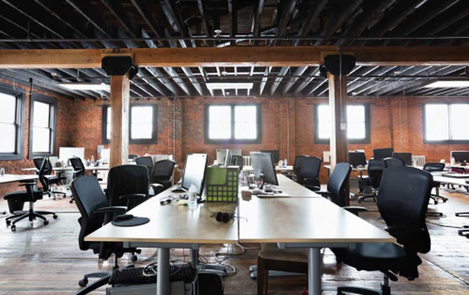 Empty chairs and tables in an office loft.