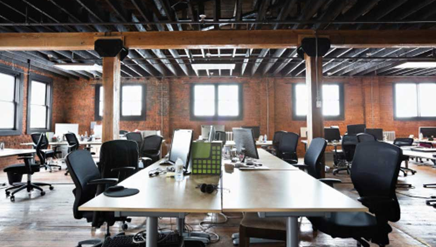 Empty chairs and tables in an office loft.