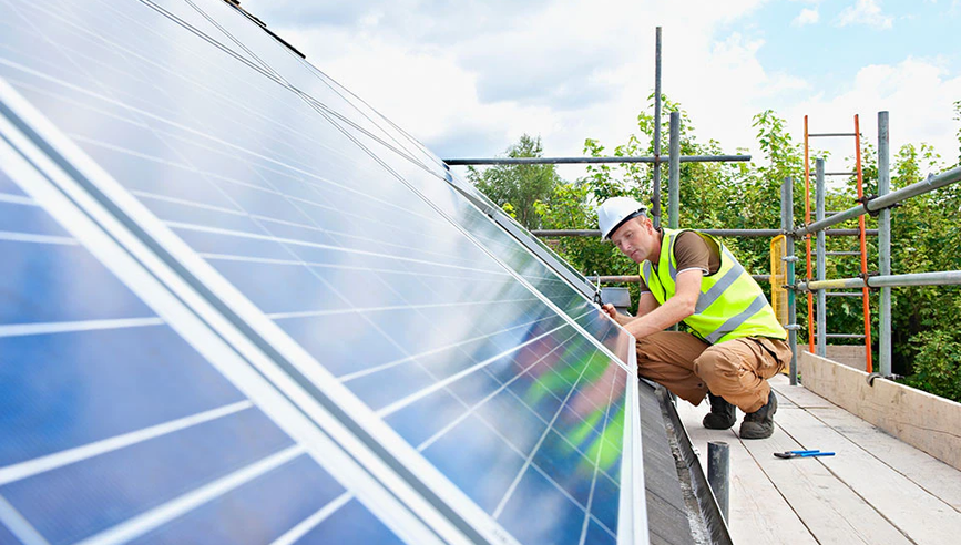 Energy professional installing solar panels.