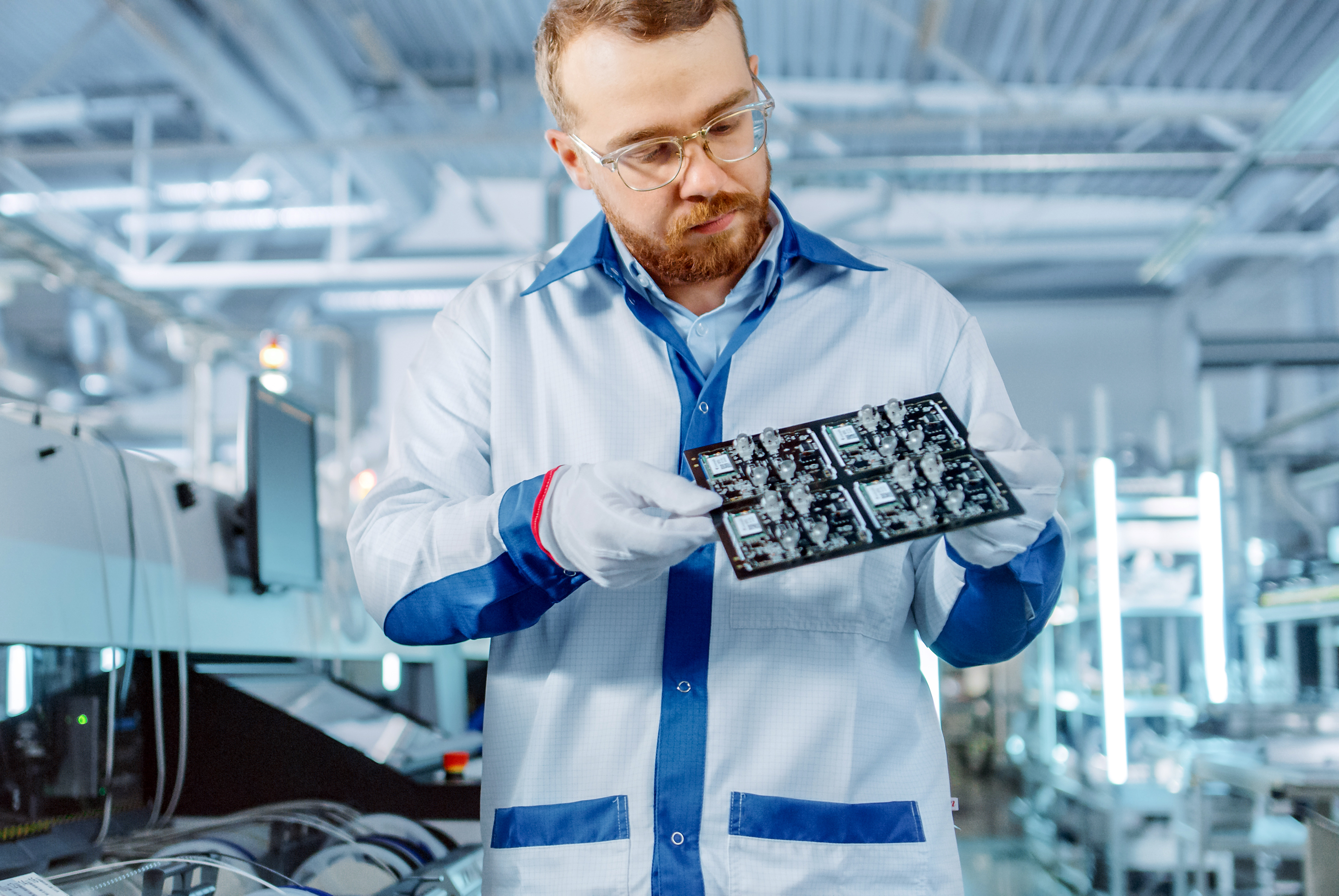 Engineer inspecting a semiconductor board.