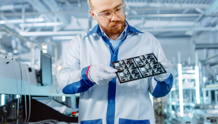 Engineer inspecting a semiconductor board.