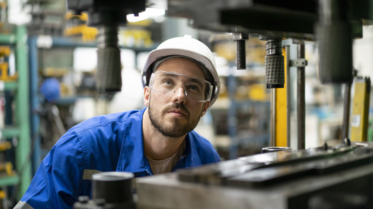 Engineer performing quality check on equipment at production line