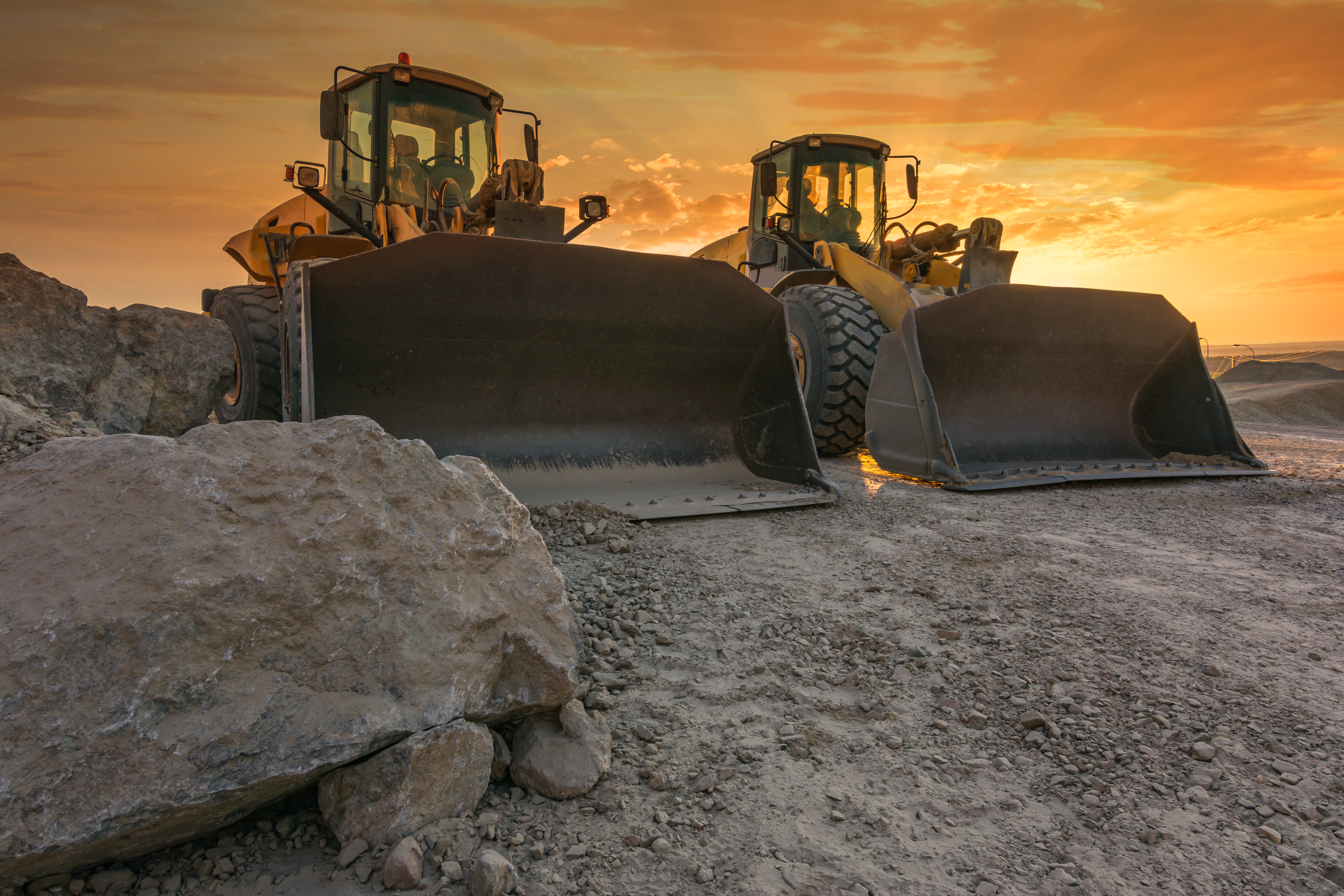 Two excavators removing stone in the construction works of a road