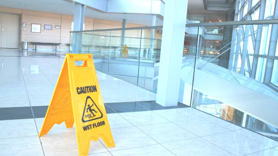 Slippery when wet sign inside a business lobby.