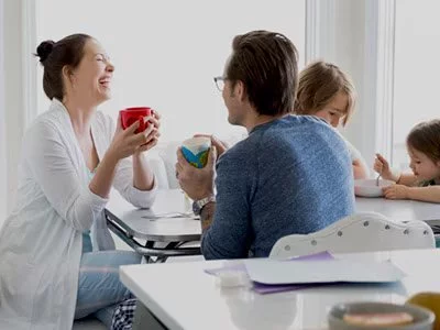 Family sitting at table at home.