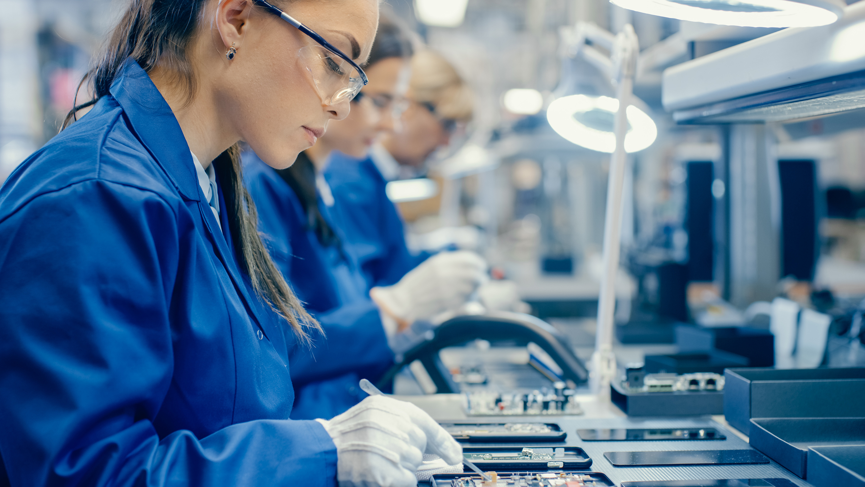 Female Electronics Factory Workers in Blue Work Coats