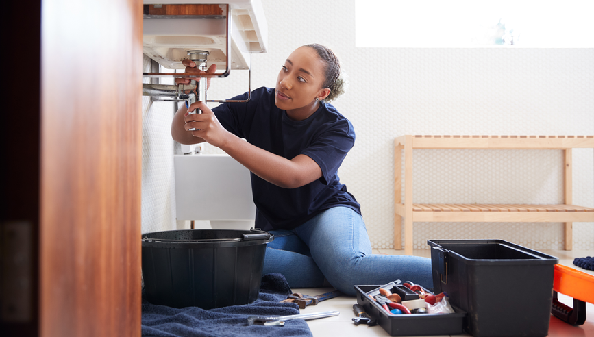 Homeowner performing repairs on a sink