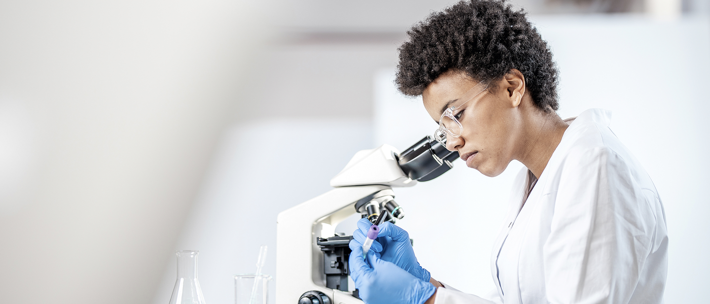 Female scientist looking in a microscope