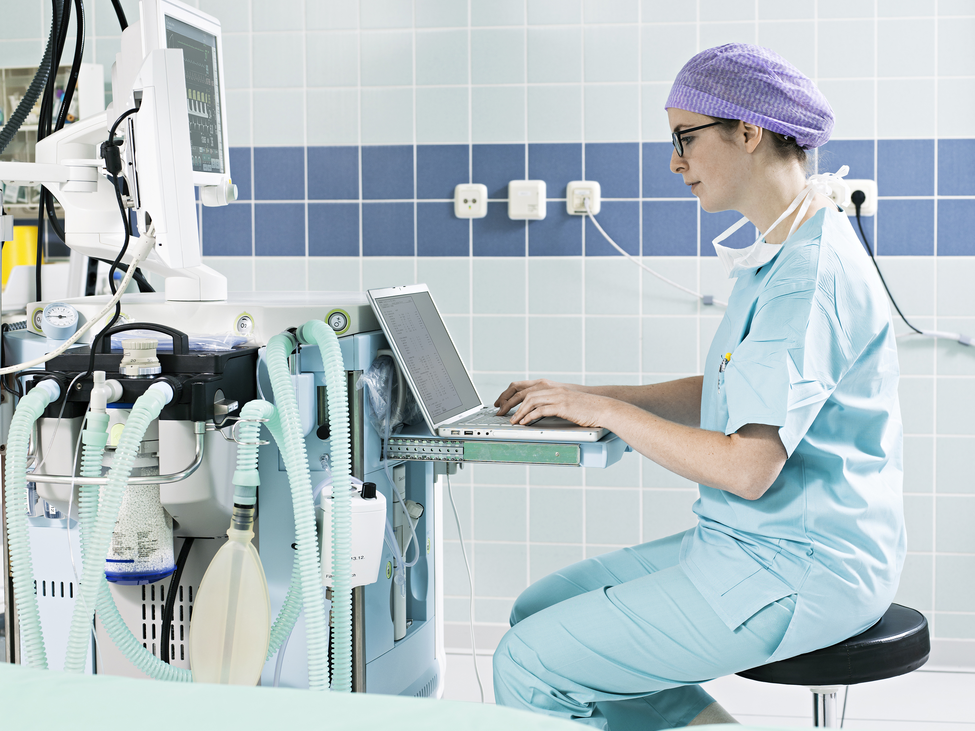 Medical technician at control console.