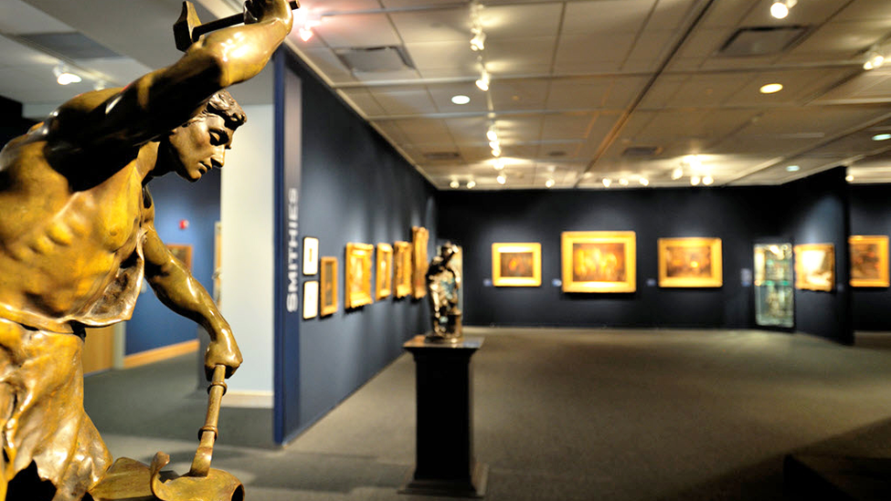 A room in a museum with statue of a man.