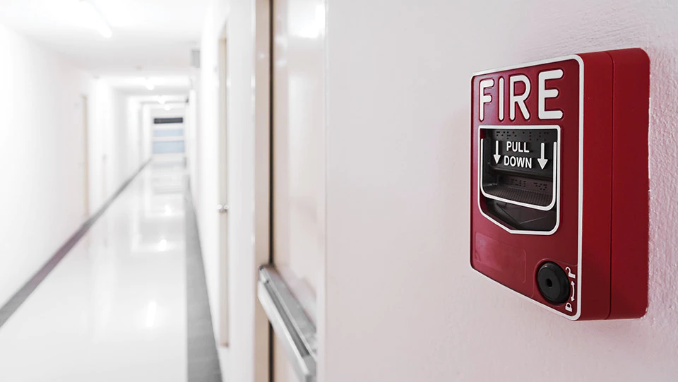 Fire alarm in a hallway as part of fire safety plan.