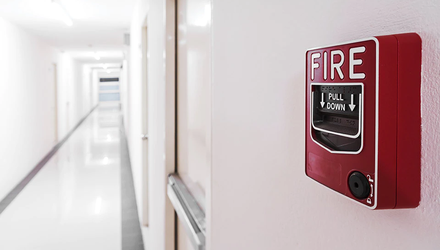 Fire alarm in a hallway as part of fire safety plan.