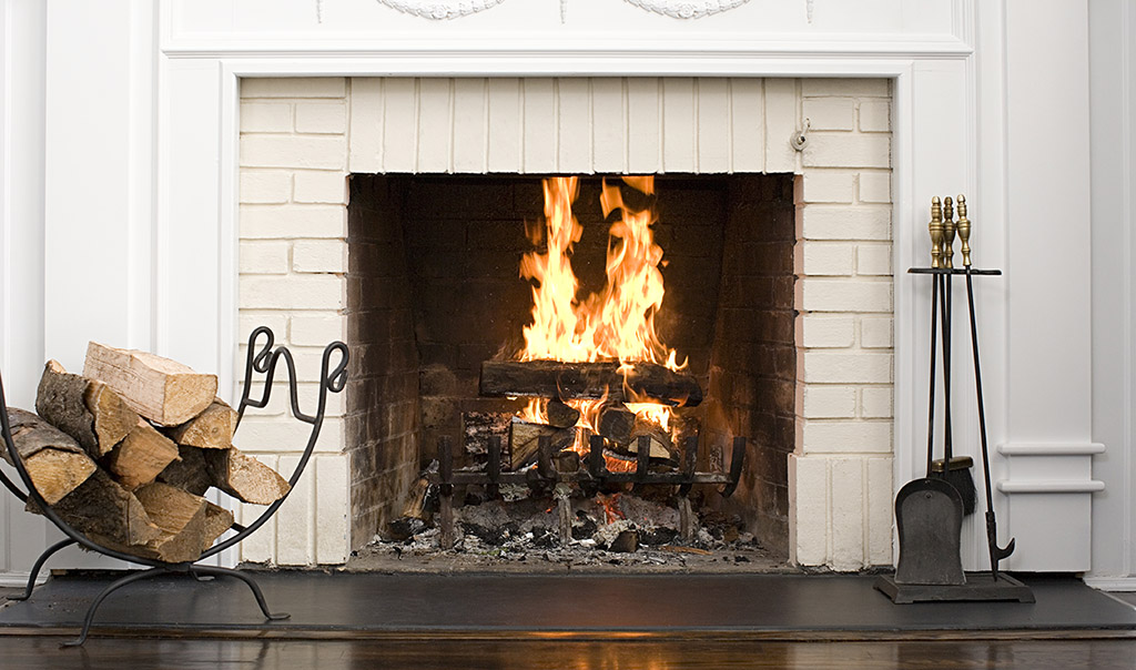 indoor fireplace with lit fire.