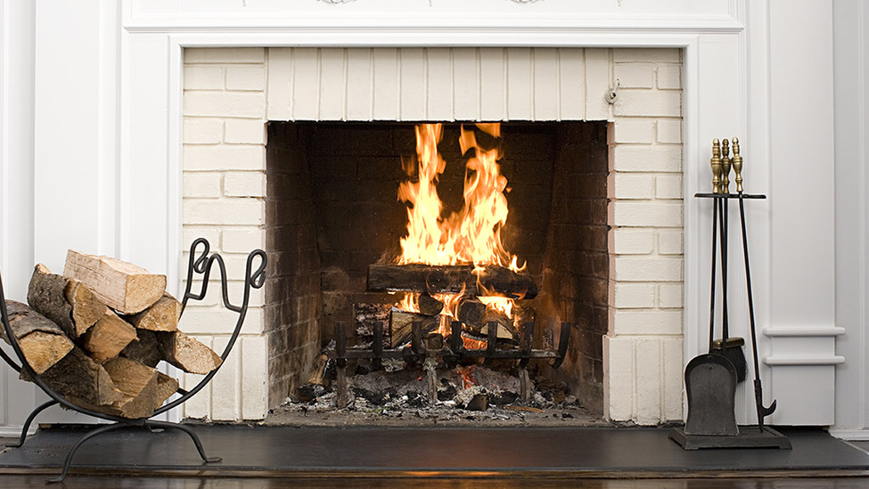 indoor fireplace with lit fire.