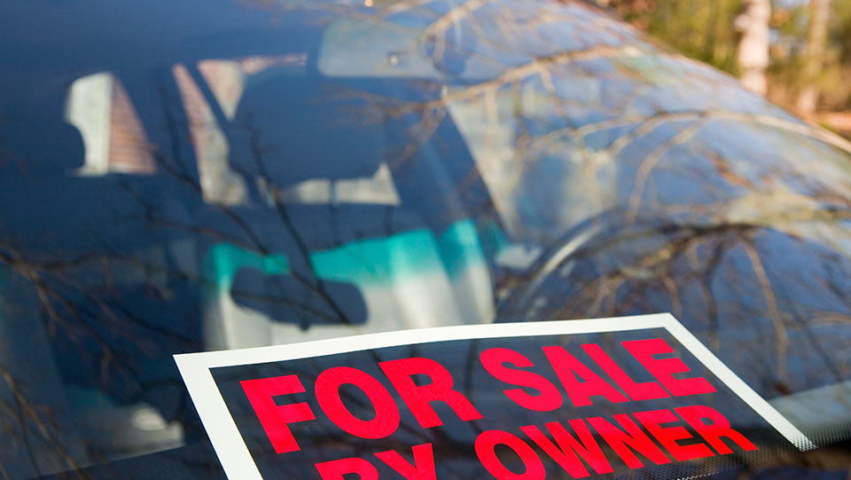 For sale by owner sign on car windshield.