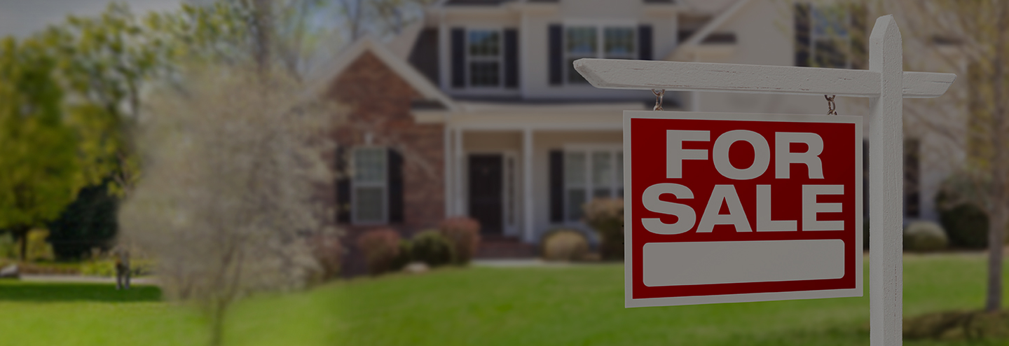 For sale sign in front of a home.