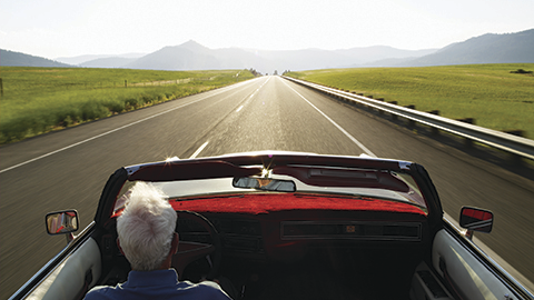 man driving card on road.