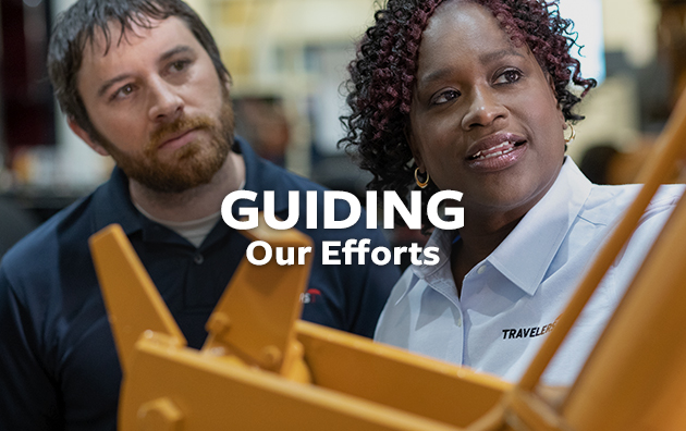 Two employees looking at machinery with text overlay reading "Guiding Our Efforts".