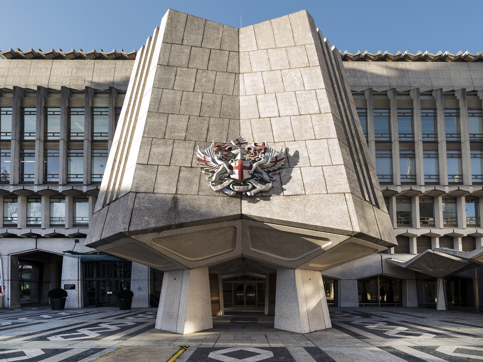 Sun illuminates the west-wing facade of the Guildhall of the City of London.