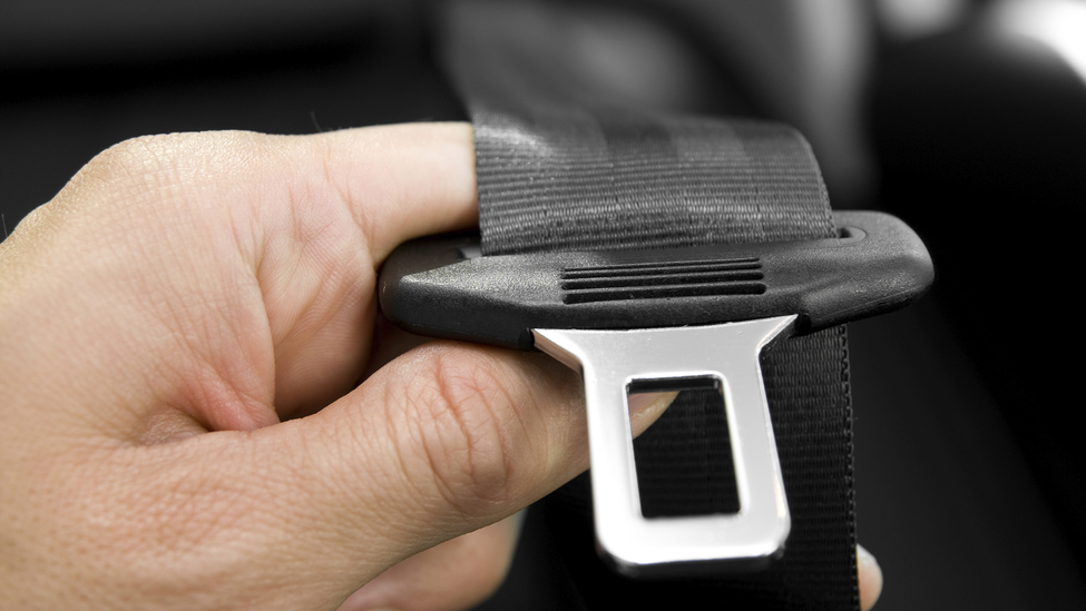 Man holding seat belt buckle