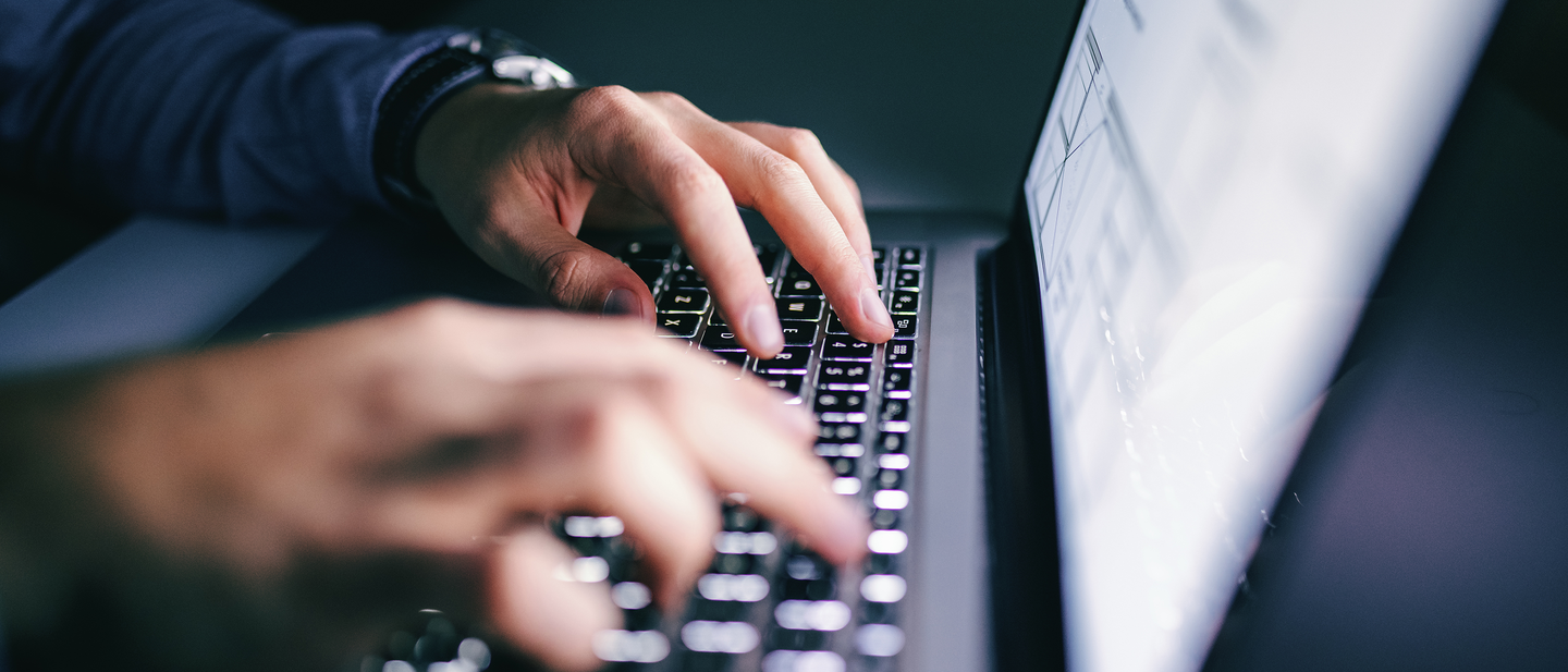 Close up of hands typing on laptop