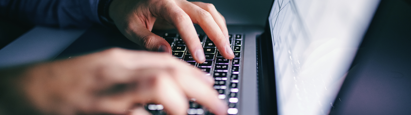 Close up of hands typing on laptop