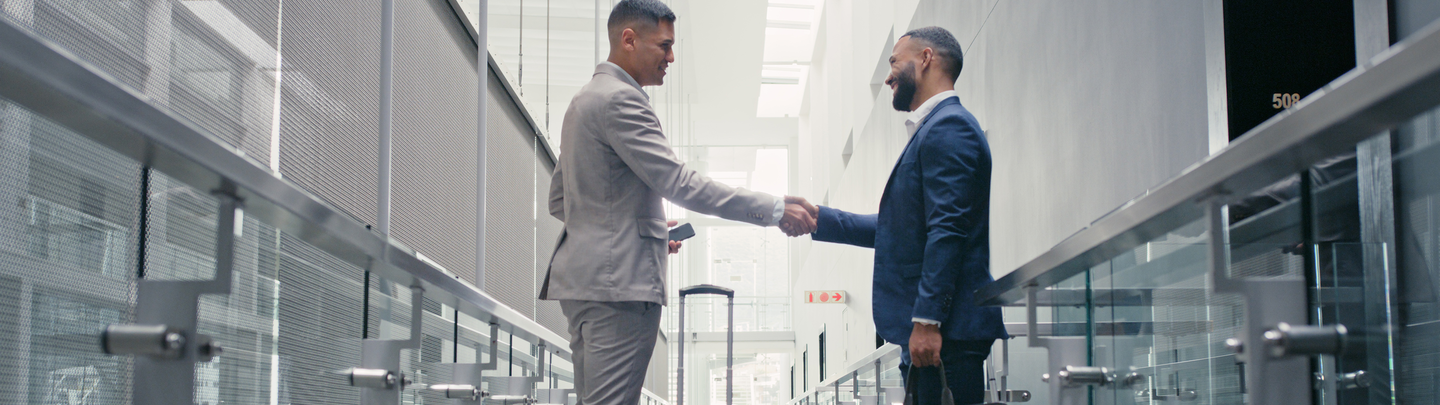 Two business men shaking hands in the office