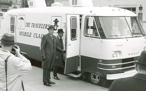 Black and white photo of an original Travelers mobile claim center bus.