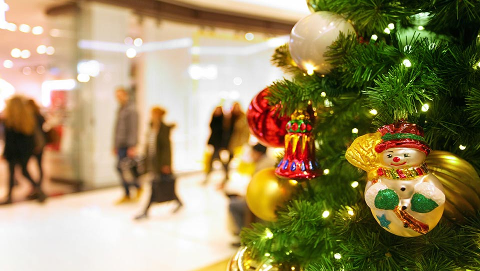 snowman ornament on a tree in a business during holiday season