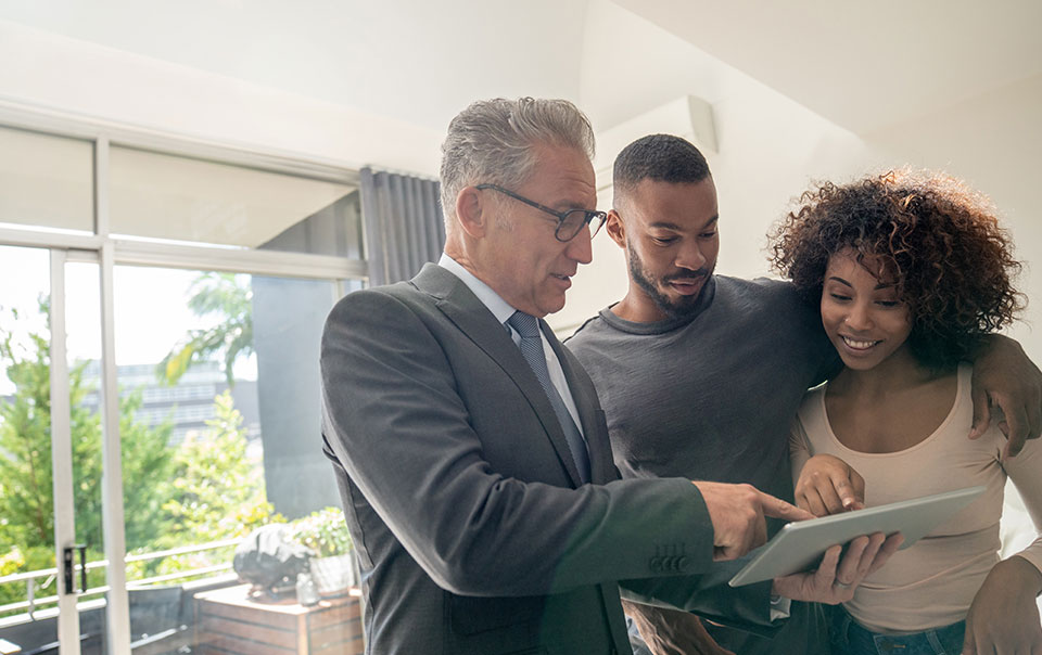 Couple talking to agent in home