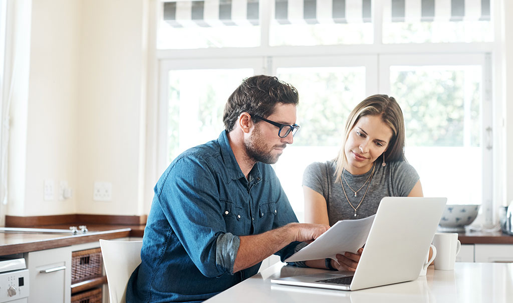 man-and-woman-leaning-over-laptop