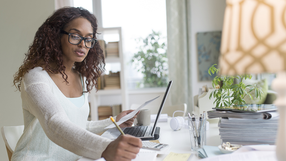 Woman sitting at computer in home office