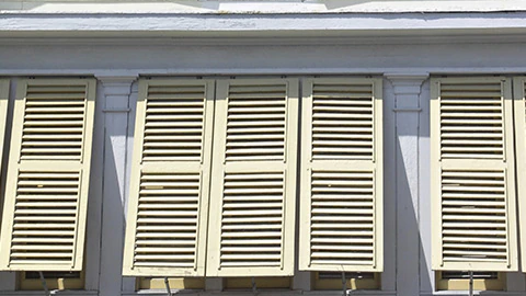 Hurricane shutters on the side of a house.