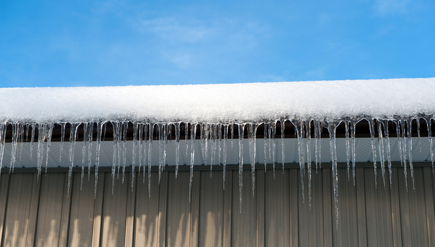 Long icicles hanging from a roof.